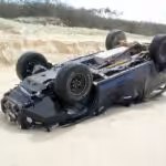 Picture of 4x4 vehicle smashed on a beach