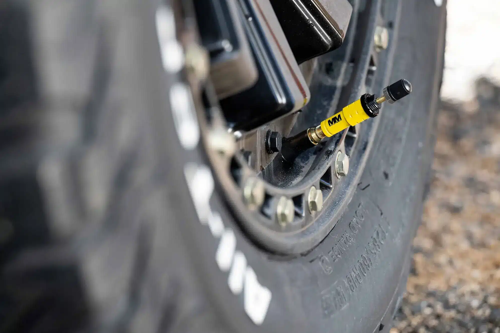 A tyre-pressure gauge on a tyre