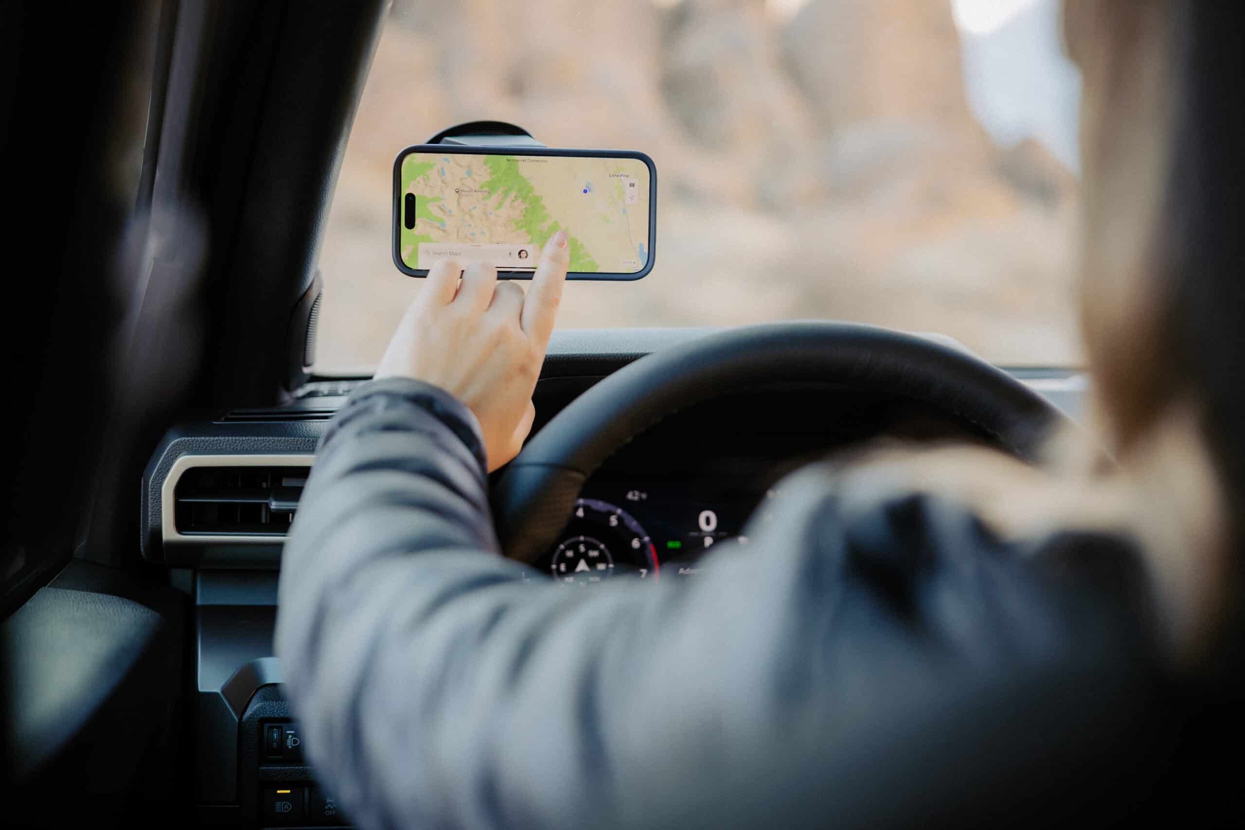 Quad Lock phone mount system installed in Jeep showing wireless charging capability and secure mounting