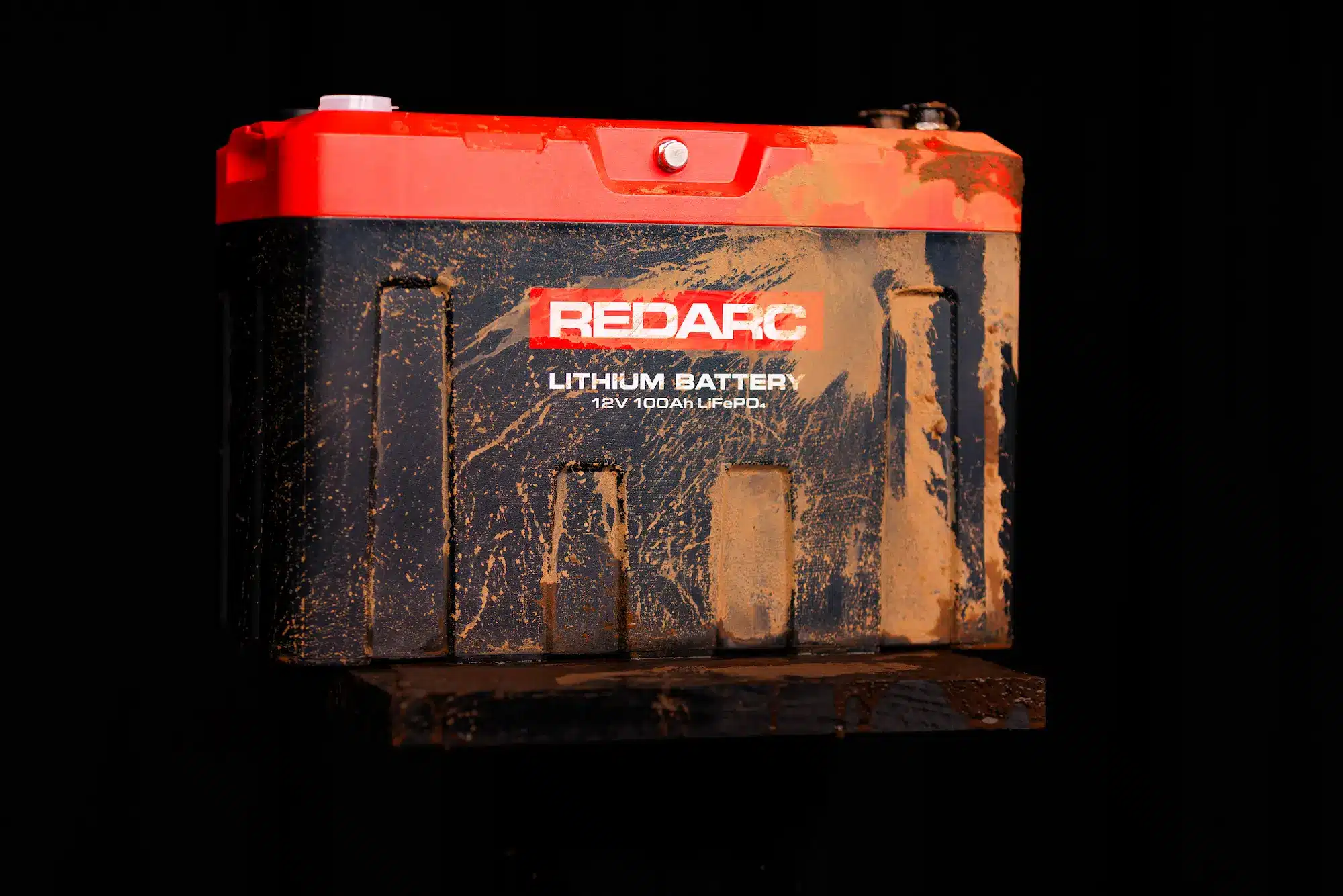 REDARC REDLAB lithium battery covered in mud demonstrating IP67 rating durability