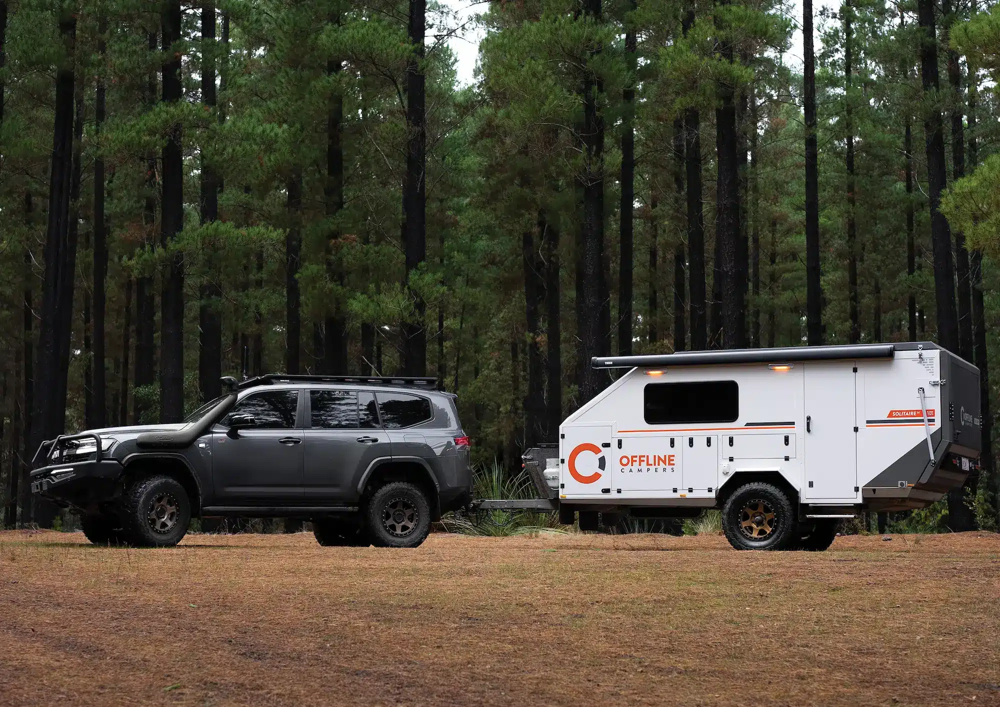 Award-winning Solitaire hybrid camper towed by 4WD showing aerodynamic design