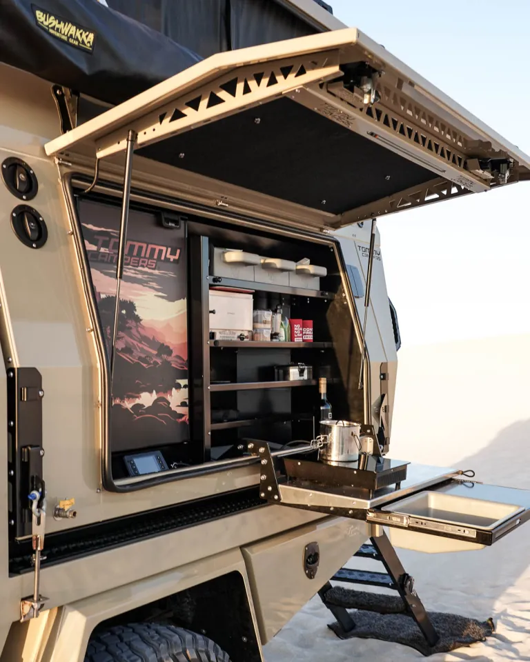 Tommy Camper S6X: Exterior kitchen setup with Bushman fridge and Travel Buddy oven