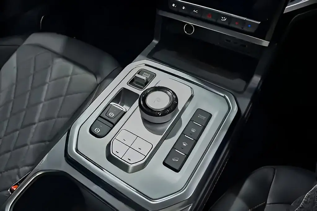 Close-up of the rotary gear dial and park brake controls.