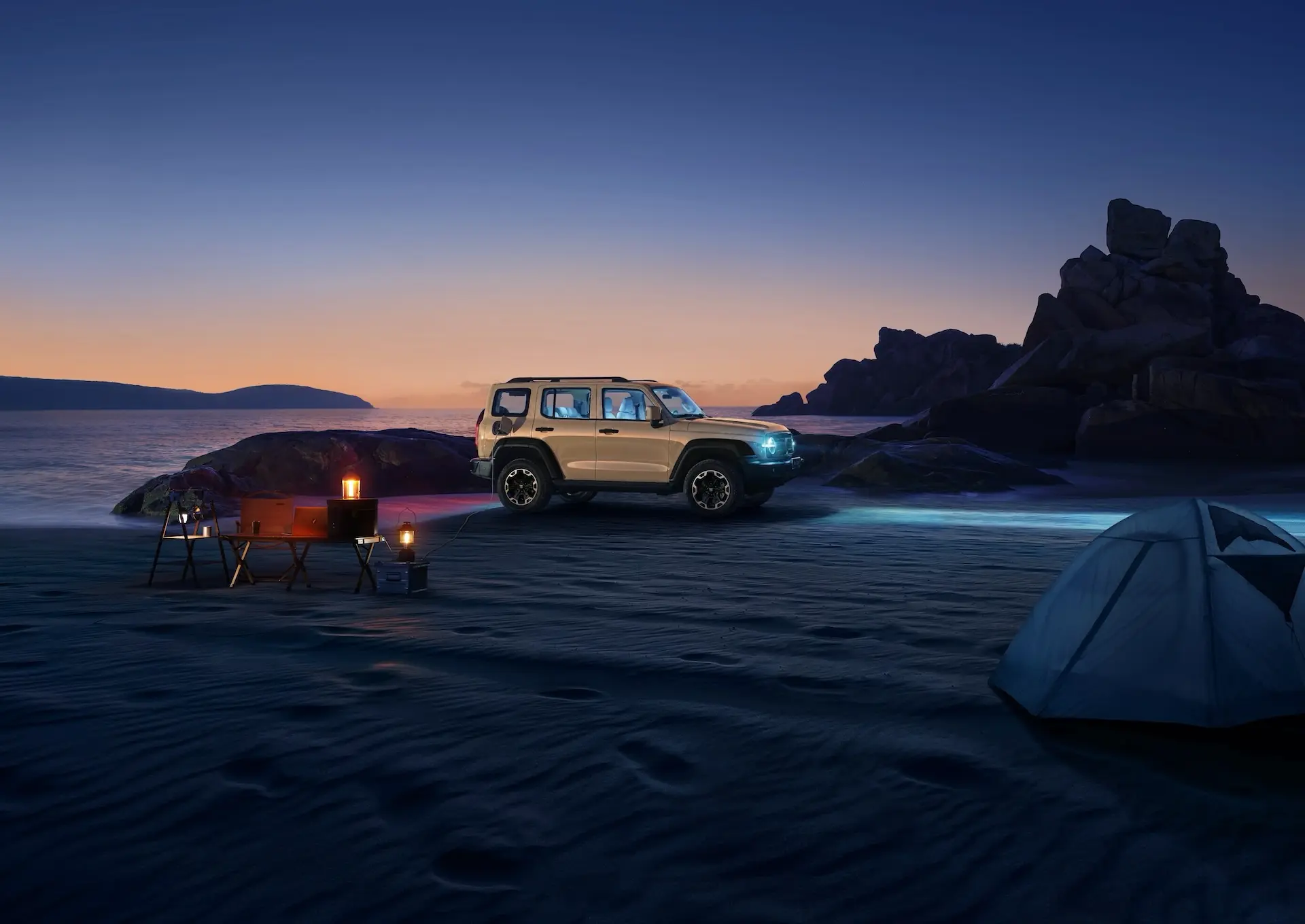 Tank 300 PHEV parked on a beach at night with a camp set up