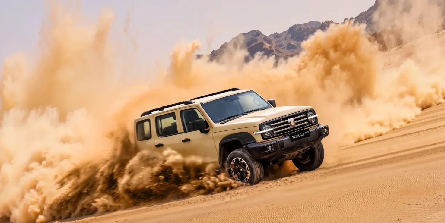 GWM Tank 300 driving through a dirt track kicking up dust