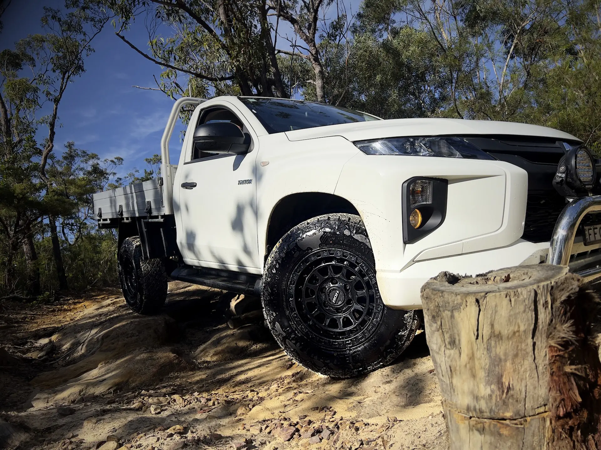 Predator New Mutant XATs: All-terrain tyres fitted to ROH Assault wheels on a white Mitsubishi Triton driving on a dirt track